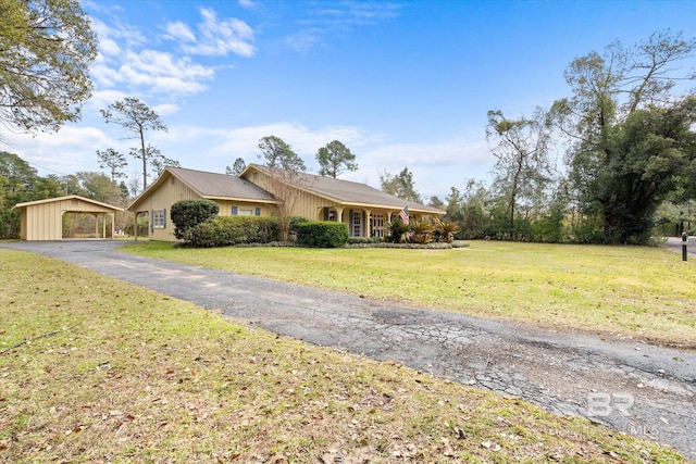 single story home featuring aphalt driveway and a front lawn