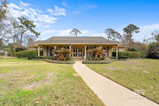 ranch-style home featuring a front yard and french doors