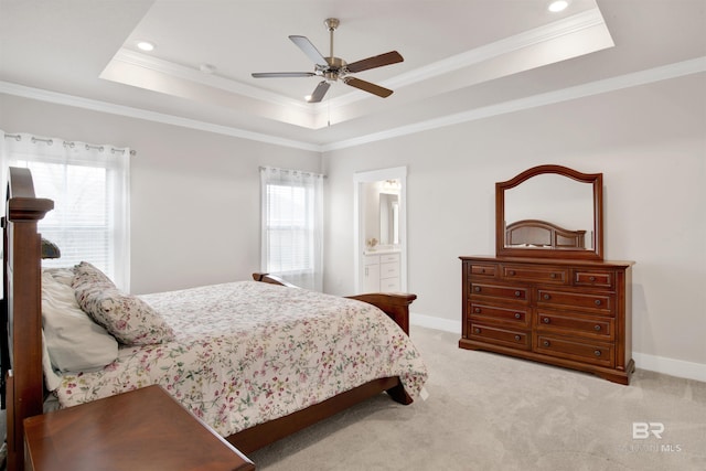 bedroom with a tray ceiling, multiple windows, and baseboards