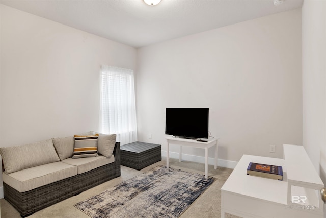 living room featuring light carpet and baseboards