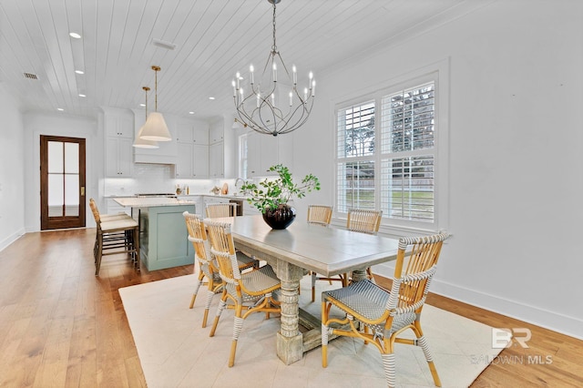 dining space featuring wooden ceiling, an inviting chandelier, light wood-style flooring, and baseboards