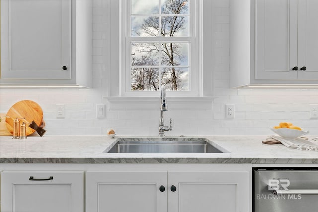 kitchen with white cabinets, a sink, backsplash, and dishwasher