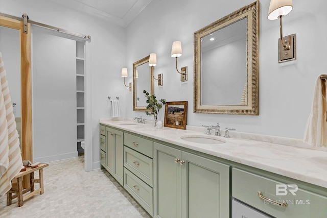 bathroom featuring double vanity, ornamental molding, toilet, and a sink