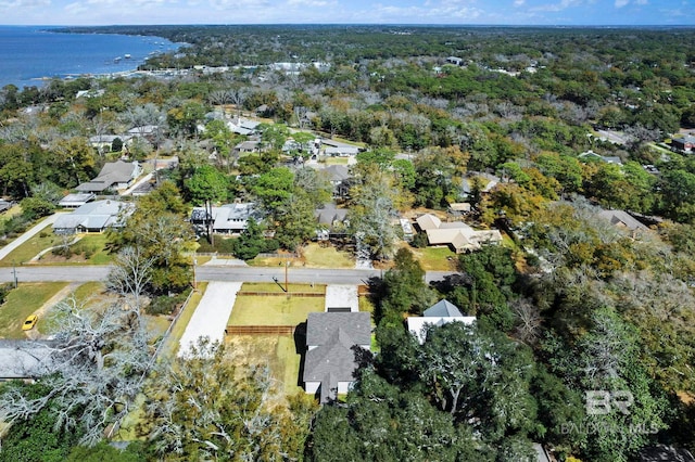 aerial view with a water view, a wooded view, and a residential view