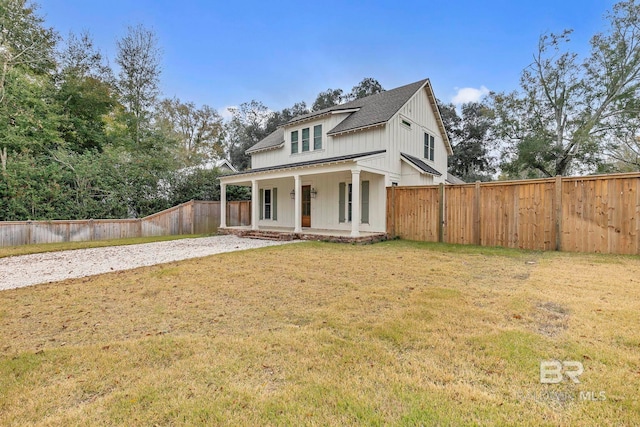 modern farmhouse style home with a porch, a fenced backyard, a shingled roof, board and batten siding, and a front yard