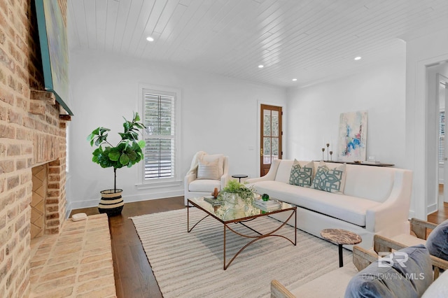 living area with a fireplace, recessed lighting, wood ceiling, wood finished floors, and baseboards