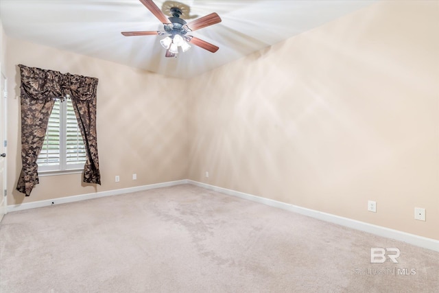 empty room with ceiling fan and light colored carpet