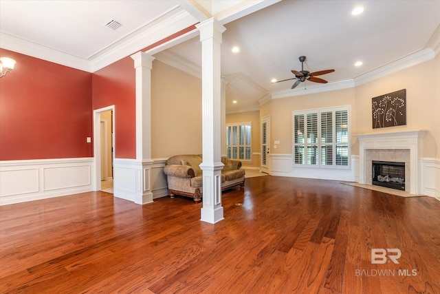 unfurnished living room featuring ceiling fan, decorative columns, hardwood / wood-style floors, and ornamental molding