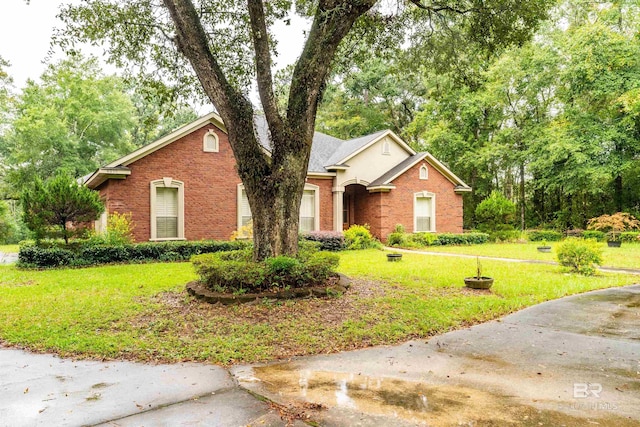 single story home with brick siding and a front lawn