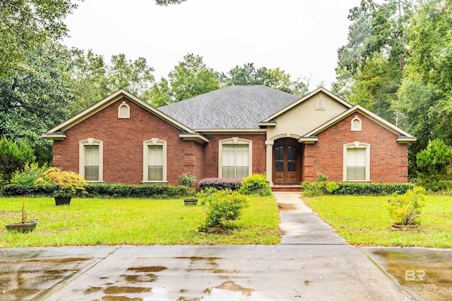 ranch-style home featuring french doors, a shingled roof, a front yard, and brick siding