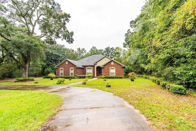 ranch-style house with aphalt driveway, a front lawn, and brick siding