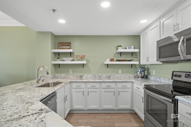 375 Beach Club Trl Unit B404, Gulf Shores, AL 36542 - kitchen featuring stainless steel appliances, open shelves, a sink, recessed lighting, and white cabinets