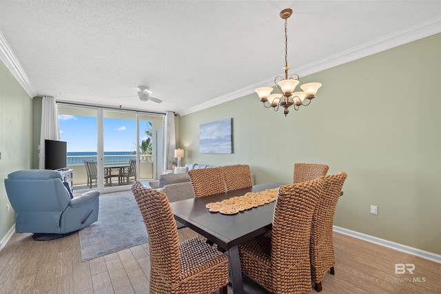 375 Beach Club Trl Unit B404, Gulf Shores, AL 36542 - dining space with ornamental molding, a chandelier, light wood-type flooring, baseboards, and a ceiling fan