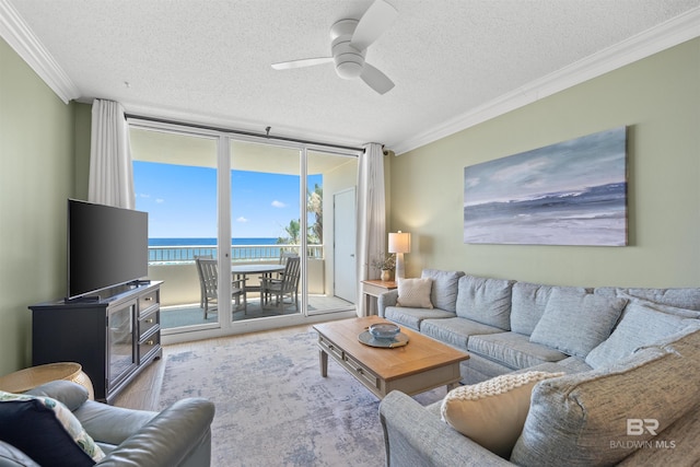375 Beach Club Trl Unit B404, Gulf Shores, AL 36542 - living area featuring expansive windows, ornamental molding, a textured ceiling, a ceiling fan, and wood finished floors