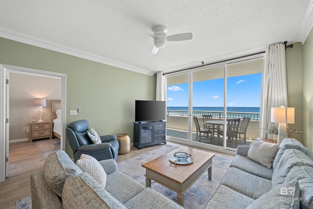 375 Beach Club Trl Unit B404, Gulf Shores, AL 36542 - living room featuring a textured ceiling, ornamental molding, a ceiling fan, wood finished floors, and floor to ceiling windows