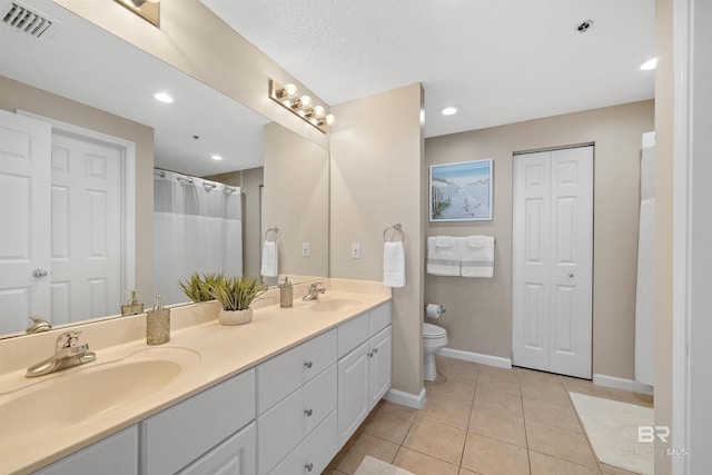 375 Beach Club Trl Unit B404, Gulf Shores, AL 36542 - bathroom with double vanity, toilet, baseboards, tile patterned floors, and a closet