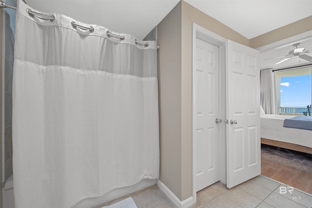 375 Beach Club Trl Unit B404, Gulf Shores, AL 36542 - ensuite bathroom featuring tile patterned floors, a ceiling fan, baseboards, and shower / bath combo