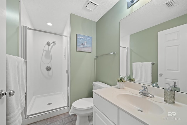 375 Beach Club Trl Unit B404, Gulf Shores, AL 36542 - full bathroom with a shower stall, vanity, toilet, wood finished floors, and a textured ceiling