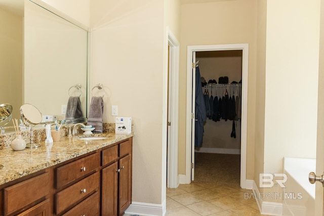 bathroom featuring a tub to relax in, tile patterned flooring, and vanity