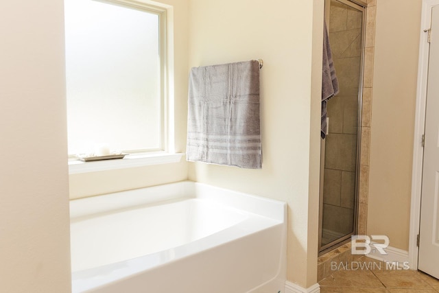 bathroom featuring shower with separate bathtub and tile patterned floors