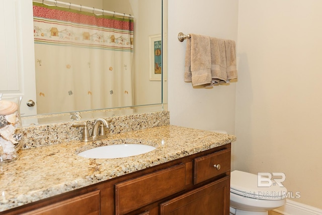 bathroom featuring vanity and toilet