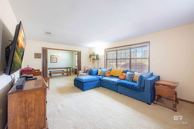 living room featuring baseboards, visible vents, a textured ceiling, light carpet, and a notable chandelier