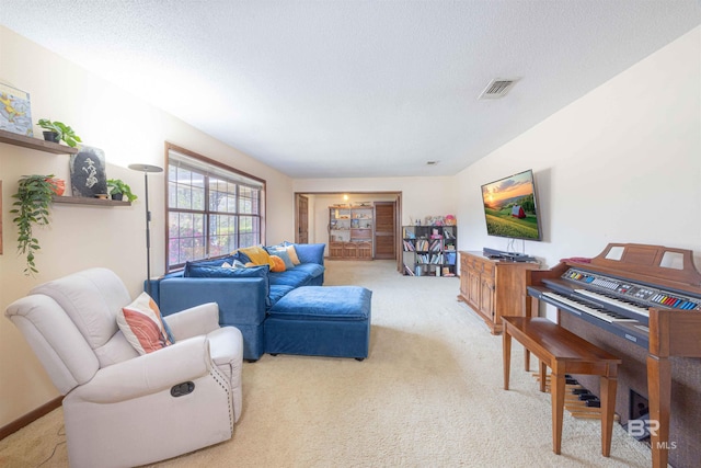 living area featuring light carpet, visible vents, a textured ceiling, and baseboards