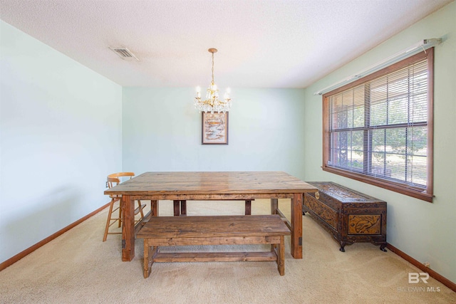 dining area featuring carpet flooring, baseboards, visible vents, and a chandelier