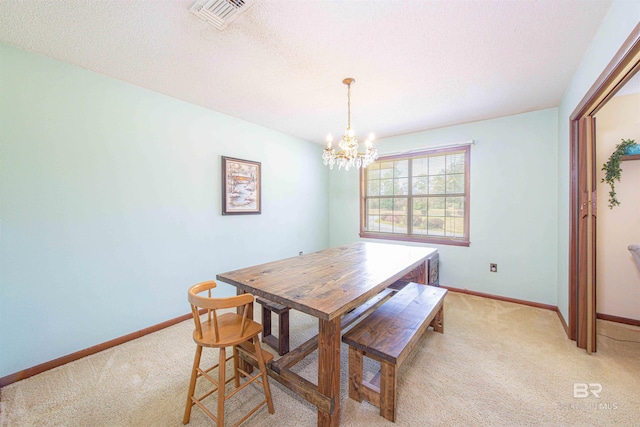 dining space with visible vents, baseboards, light colored carpet, and a chandelier