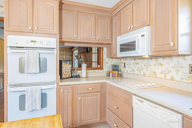 kitchen with white appliances, light brown cabinets, and wallpapered walls