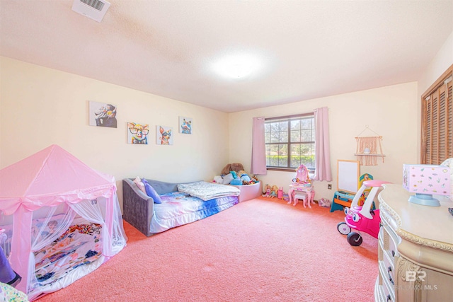 carpeted bedroom featuring visible vents, a closet, and a textured ceiling