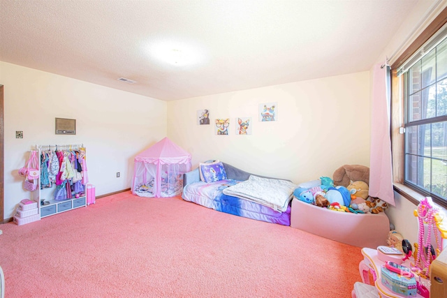 carpeted bedroom featuring visible vents and a textured ceiling