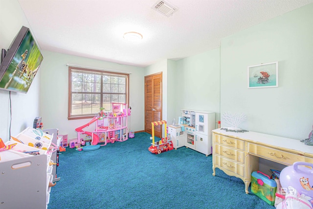 rec room featuring carpet, visible vents, and a textured ceiling