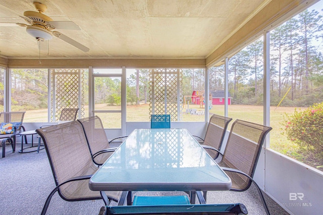 sunroom with a wealth of natural light and a ceiling fan