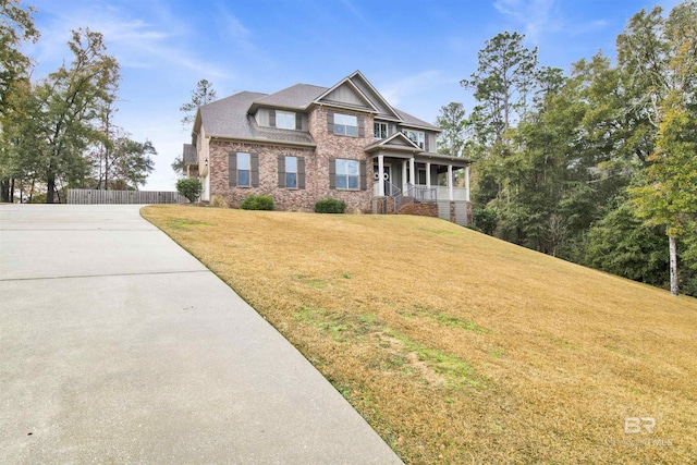 craftsman-style house with a porch and a front lawn