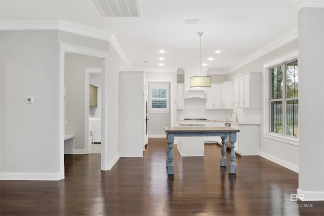 kitchen featuring ornamental molding, decorative light fixtures, decorative backsplash, and white cabinets