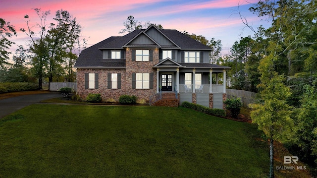 craftsman-style house featuring a porch and a yard