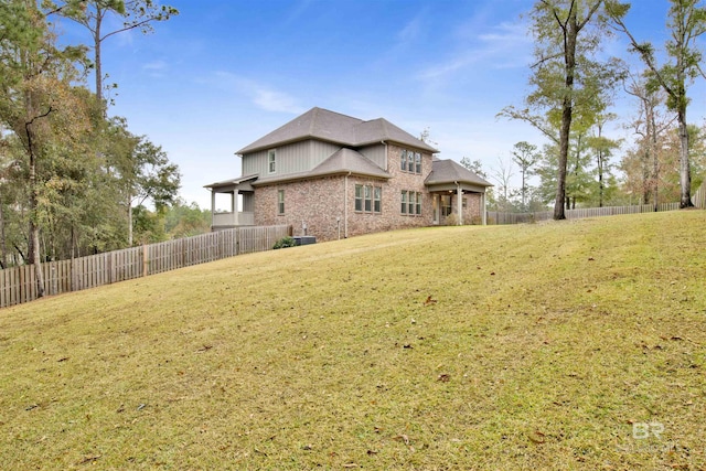 rear view of property with a yard