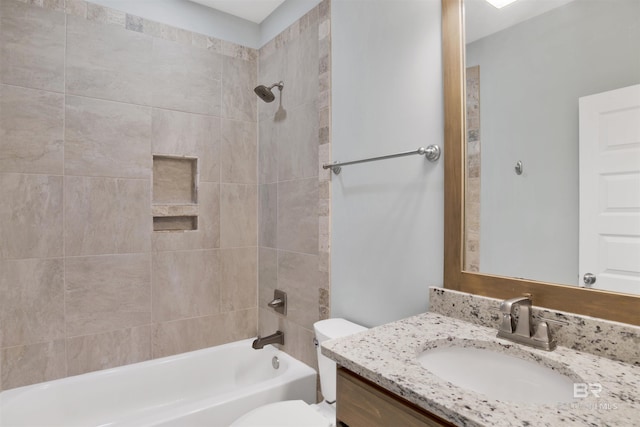 full bathroom with vanity, toilet, and tiled shower / bath combo