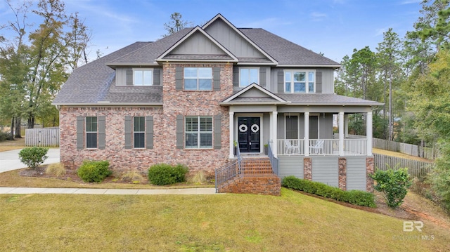 craftsman inspired home with a front yard and covered porch