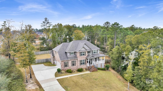 craftsman inspired home featuring a front lawn and a porch