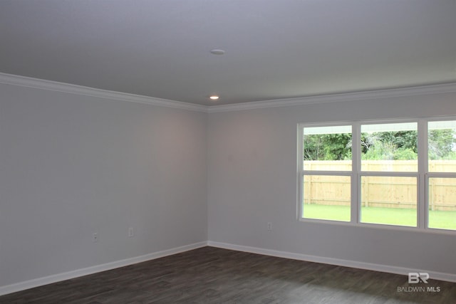 empty room featuring crown molding, baseboards, dark wood-type flooring, and recessed lighting