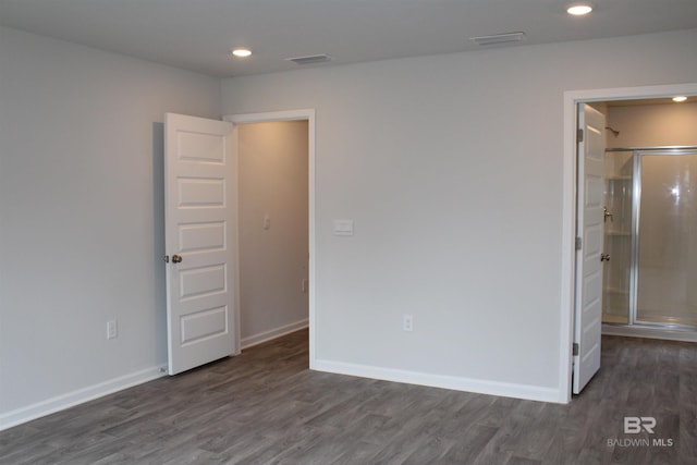 unfurnished bedroom with recessed lighting, dark wood-style flooring, and baseboards