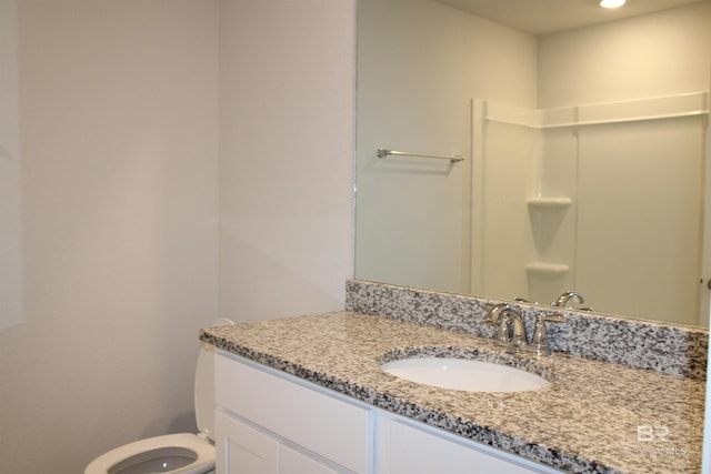 bathroom with toilet and vanity