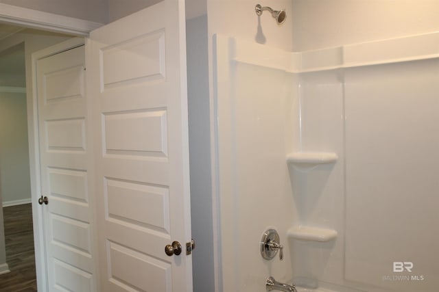 full bath featuring bathtub / shower combination and wood finished floors