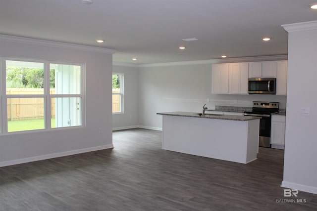 kitchen featuring white cabinetry, stainless steel appliances, crown molding, and dark stone counters