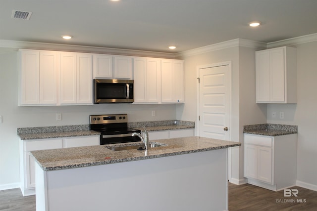 kitchen featuring stainless steel appliances, stone counters, visible vents, and a sink