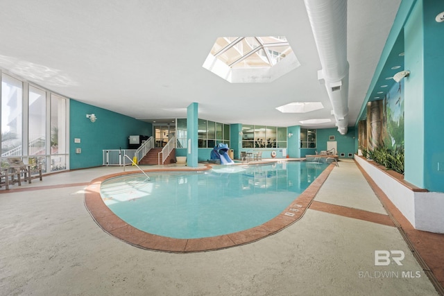 view of pool featuring a skylight