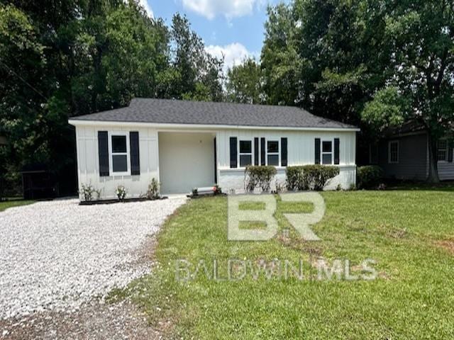 3512 Spring Hill Ave, Mobile, AL 36608 - ranch-style home with a front lawn and gravel driveway
