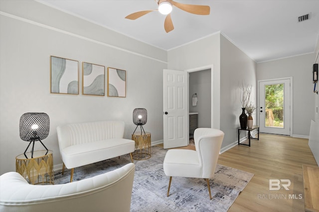 3512 Spring Hill Ave, Mobile, AL 36608 - living room featuring light wood-style floors, a ceiling fan, and ornamental molding